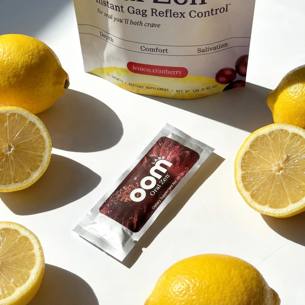 Oom instant gag reflex control package with lemon cranberry flavor on a white surface with lemons.